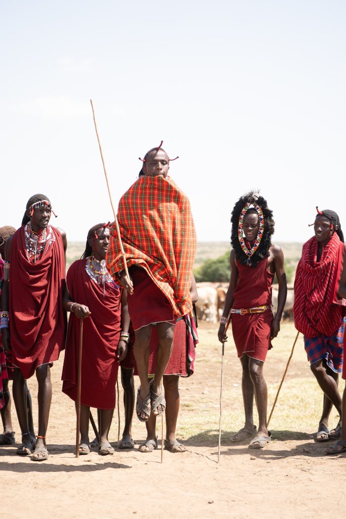 Maasai tribe members perform a traditional jumping dance in Kenya's outdoors.